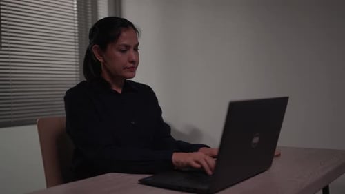 A woman sits and works late into the night and wants to present a project to the head of the morning