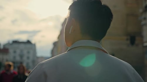 Young Adult Walking Through Urban City Street