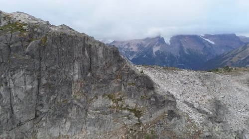 Majestic Mountain Landscape in British Columbia, Canada: A Rugged Valley View with Cloudy Skies