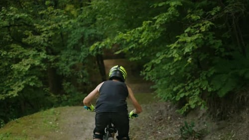Extreme Cycling in Forest Young Sporty Guy on MTB Bike is Riding Fast on Dirt Road Slow Motion