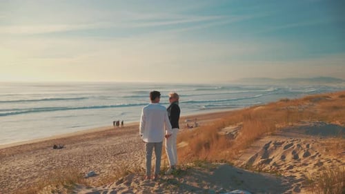 Romantic Senior Couple Holding Hands Enjoying the Ocean View