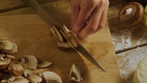 A Top View of a Housewife's Skilled Hands As She Cuts Mushrooms Into Small Pieces at Home Close Up