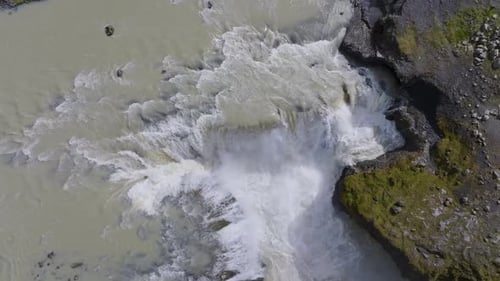 Aerial view of waterfall cascading through rocks, Iceland.