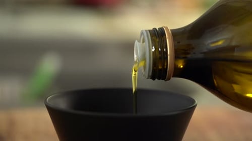 Pouring pure Extra Virgin Olive Oil