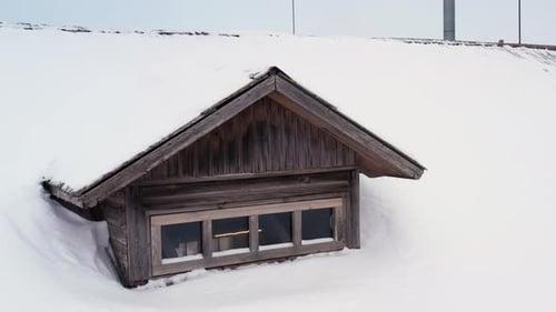 Attic Windows On Snowy Roof Of House During Winter. - aerial, close up