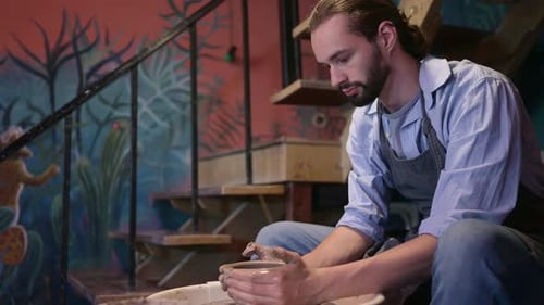 Pottery artist, Young making a piece of clay molding calmly