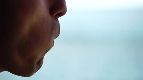 Close Up of a Man Eating a Sandwich