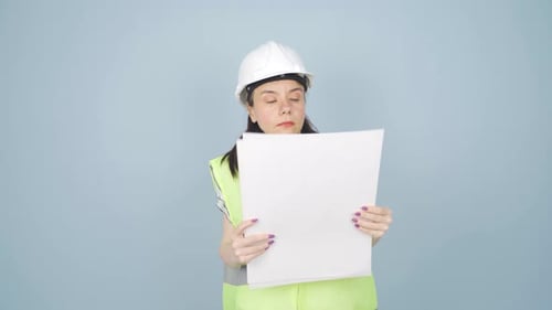 The engineer examines the project in her hands.