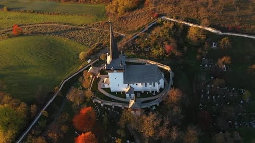 Flying Above Old Whitewashed Reformed Church and Village in Autumn Aerial, Transylvania, Romania