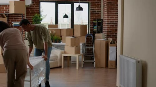 Couple Moving Shelving Unit Into New Apartment