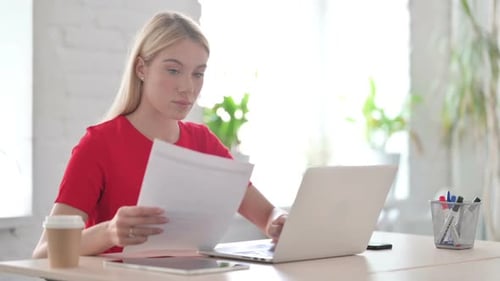 Woman Working on Laptop in Bright Office