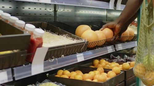 Unrecognizable Man Buying Pomelo in Grocery Shop