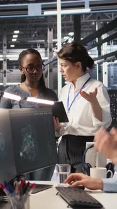 Vertical Video Data Center Teamworking Colleagues Performing Maintenance on Server Racks