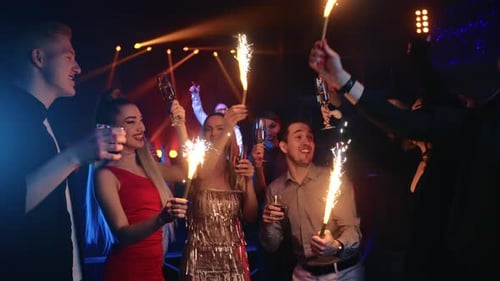 Excited Friends Celebrate with Sparklers and Champagne