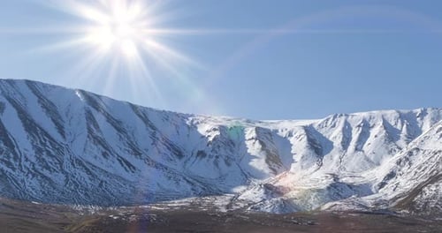 Timelapse of Sun Movement on Crystal Clear Sky Over Snow Mountain Top