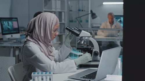 Muslim Scientist Using Microscope