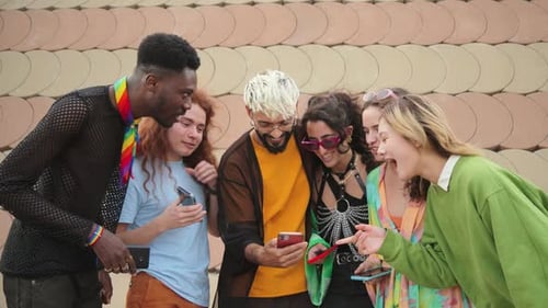 Group of Friends Laughing While Looking at Phones