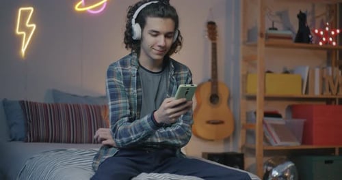 Young Adult Listening to Music on Phone