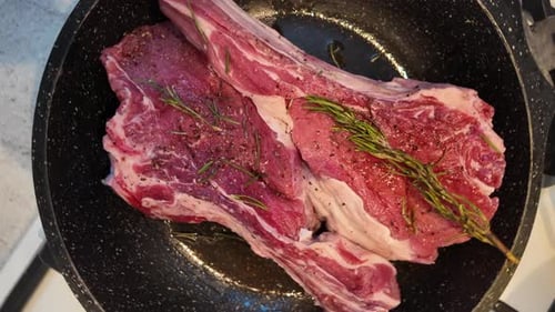 Two Bone-In Steaks in Frying Pan