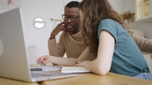 Couple Planning Together at Home With Laptop