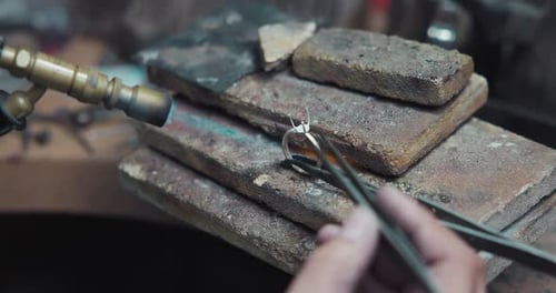 Jeweler Solders a Silver Blank with a Gas Burner in the Process of Creating a Jewelry Ring