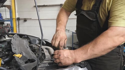 Auto Mechanic Disassembling Car Before Repair at Workshop or Service