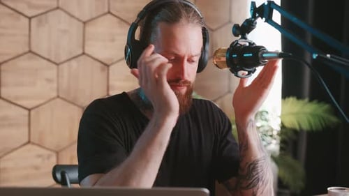 Young Caucasian Man Blogger Recording Audio Podcast Using Studio Microphone