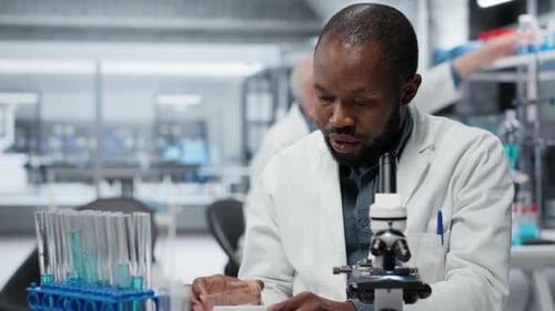 Focused Scientist Examines Sample in Bright Modern Laboratory