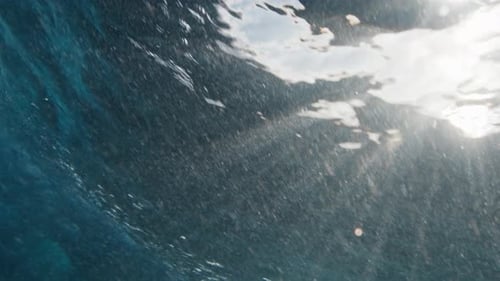 Underwater View of the Ocean Wave Breaking on the Shore in the Maldives at Sunset