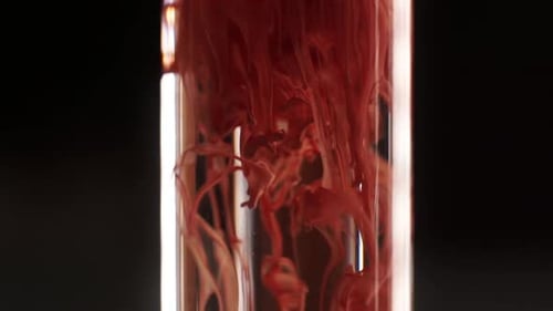 Drop Paint color mixture falls on water Colorful ink in water on black background. Slow motion