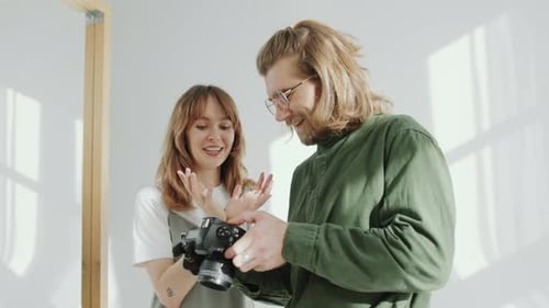Young Adults Laughing While Looking at Digital Camera
