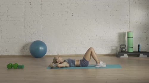Woman Doing Crunches on Yoga Mat for Fitness
