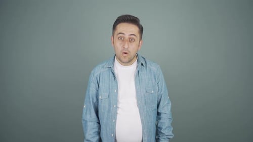 Surprised Man Looking at Camera in Studio