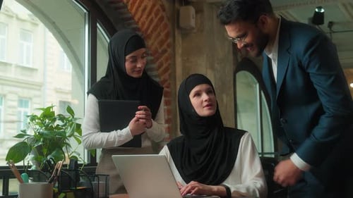 Arabian Three Coworkers Business Team in Office Talking Looking Laptop Teamwork Women Man Muslim