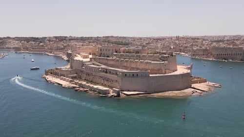 Aerial footage of Forst St. Angelo, in Birgu, Valletta, Malta at sunrise
