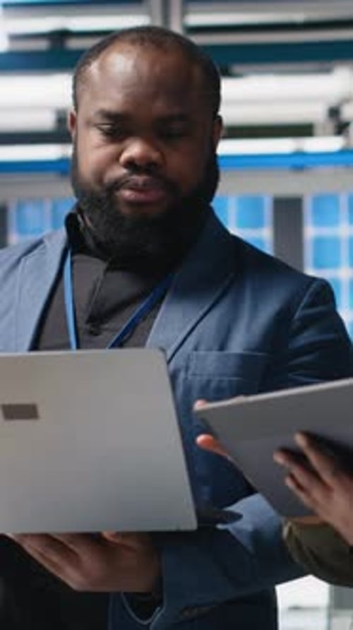 Man Discussing Work in a Tech Office