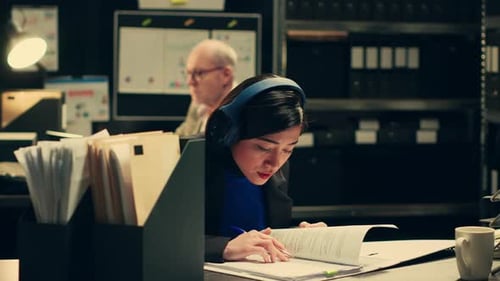 Woman Working Hard in Dimly Lit Office