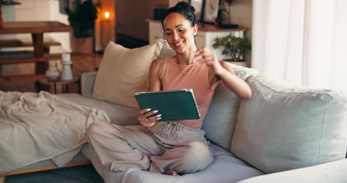 Laughing, woman and relax with tablet, lounge and watching funny movie on web, streaming and online