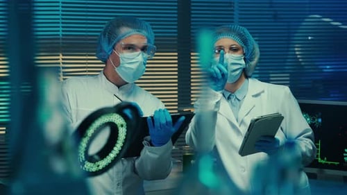 A Man Writes Data with a Pencil in a Folder and a Woman Checks the Information in a Digital Tablet