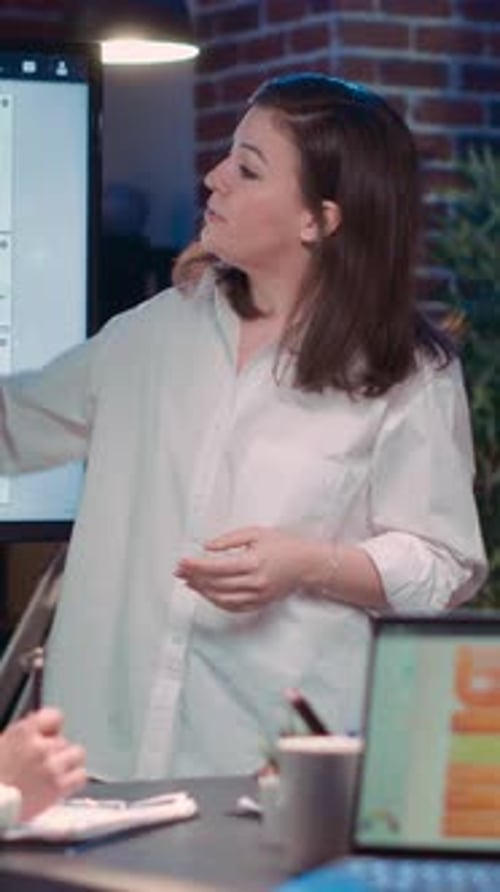 Businesswoman Delivers Presentation in Modern Office at Night
