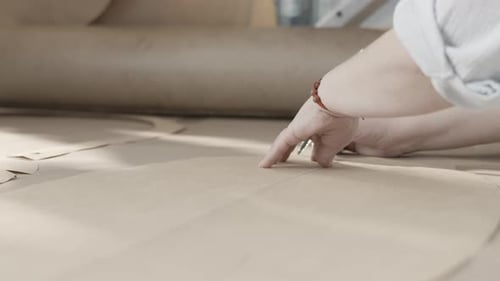 Hands Trace Pattern on Craft Paper Close Up