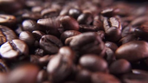 Roasted caffeine beans falling down in slow motion