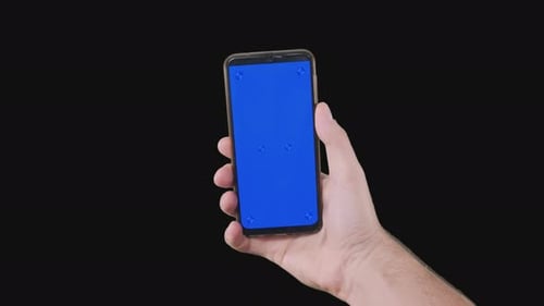 Male Hand Holding Smartphone with Blue Screen with Markers on Alpha Channel