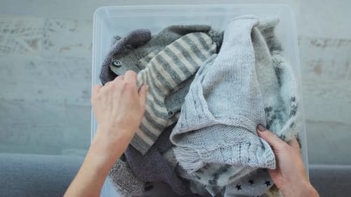 Gray Knitted Items Arranged in Clear Storage Container