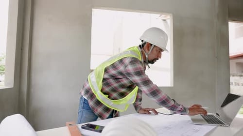 Asian male architect with construction supervisor, worker, engineer, employee Wear a white safety he