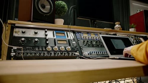 A recording studio control panel mixer with an equalizer faders buttons for broadcasting a recording