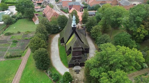 old medieval wooden church in tree remote location aerial circulating