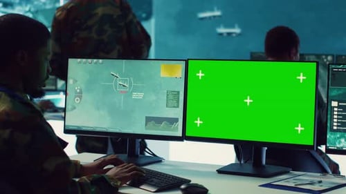 Man Types at Computer in Operations Center