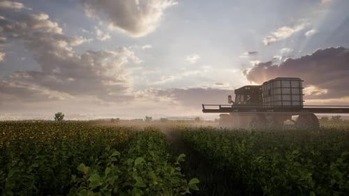 Farming Tractor Plowing And Spraying On Field