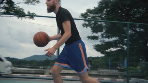 close-up active shooting, a man plays basketball and throws the ball into the basket